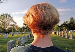 Kid looking over a cemetery