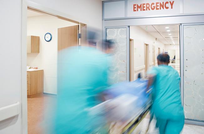 doctors rushing a patient in an ER