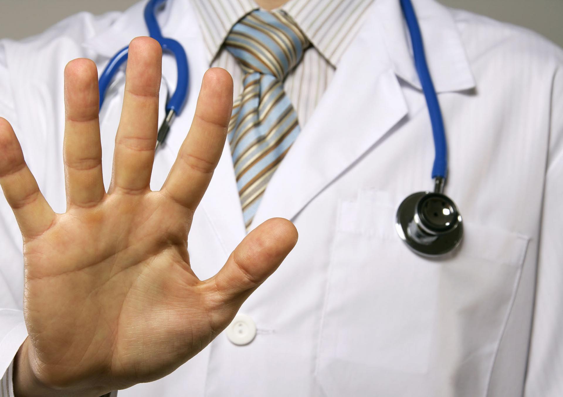 doctor holding up hand to say stop